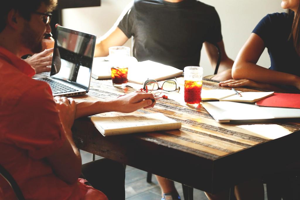 Financial coach discussing a personal budget plan with a client at a table