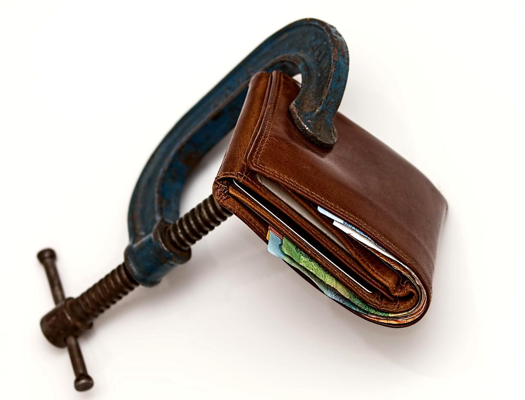 Person crossing out debts on a handwritten repayment checklist
